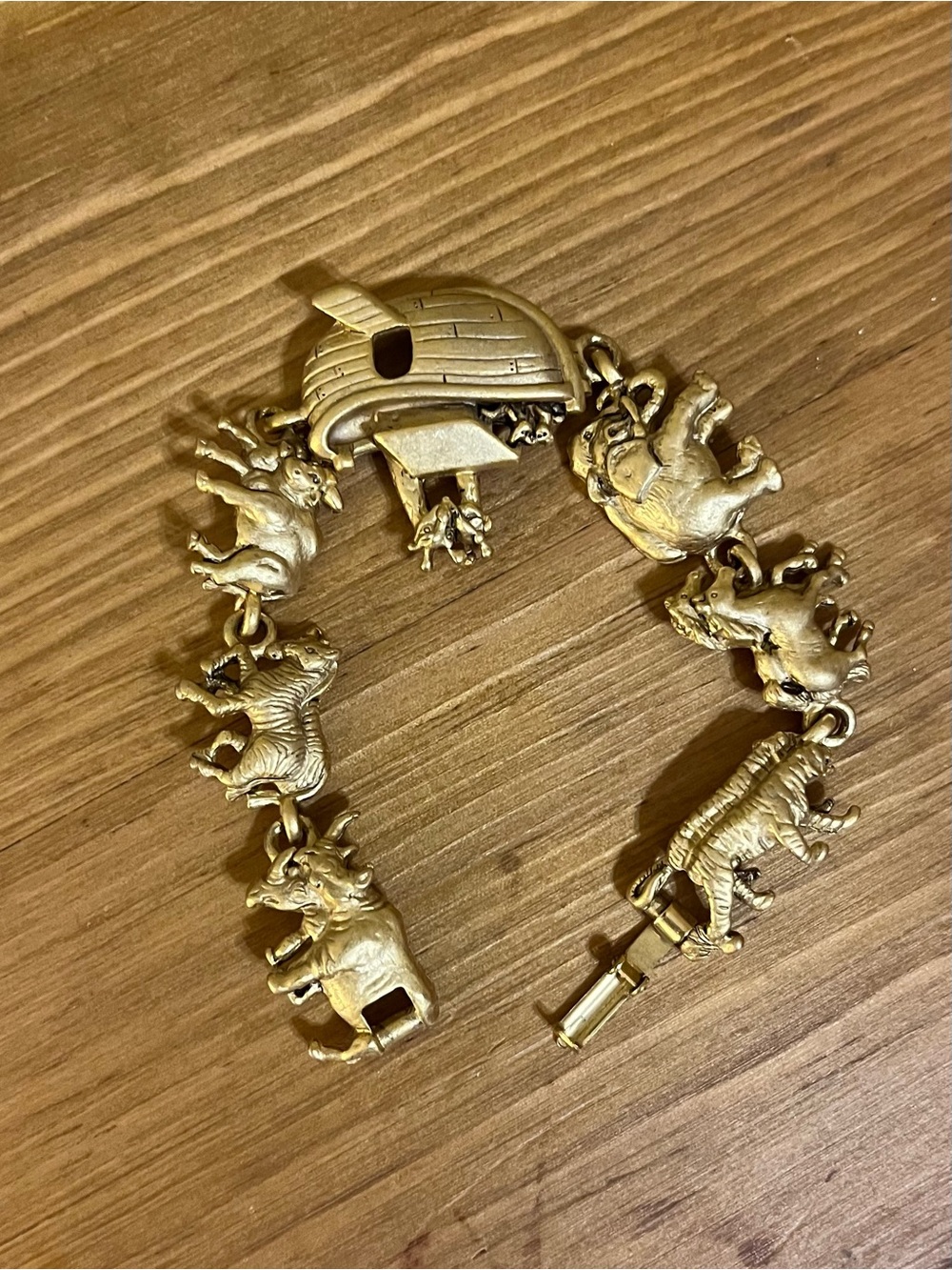 AJC signed Noah’s Ark bracelet in gold tone with a fold over clasp 6 1/4”